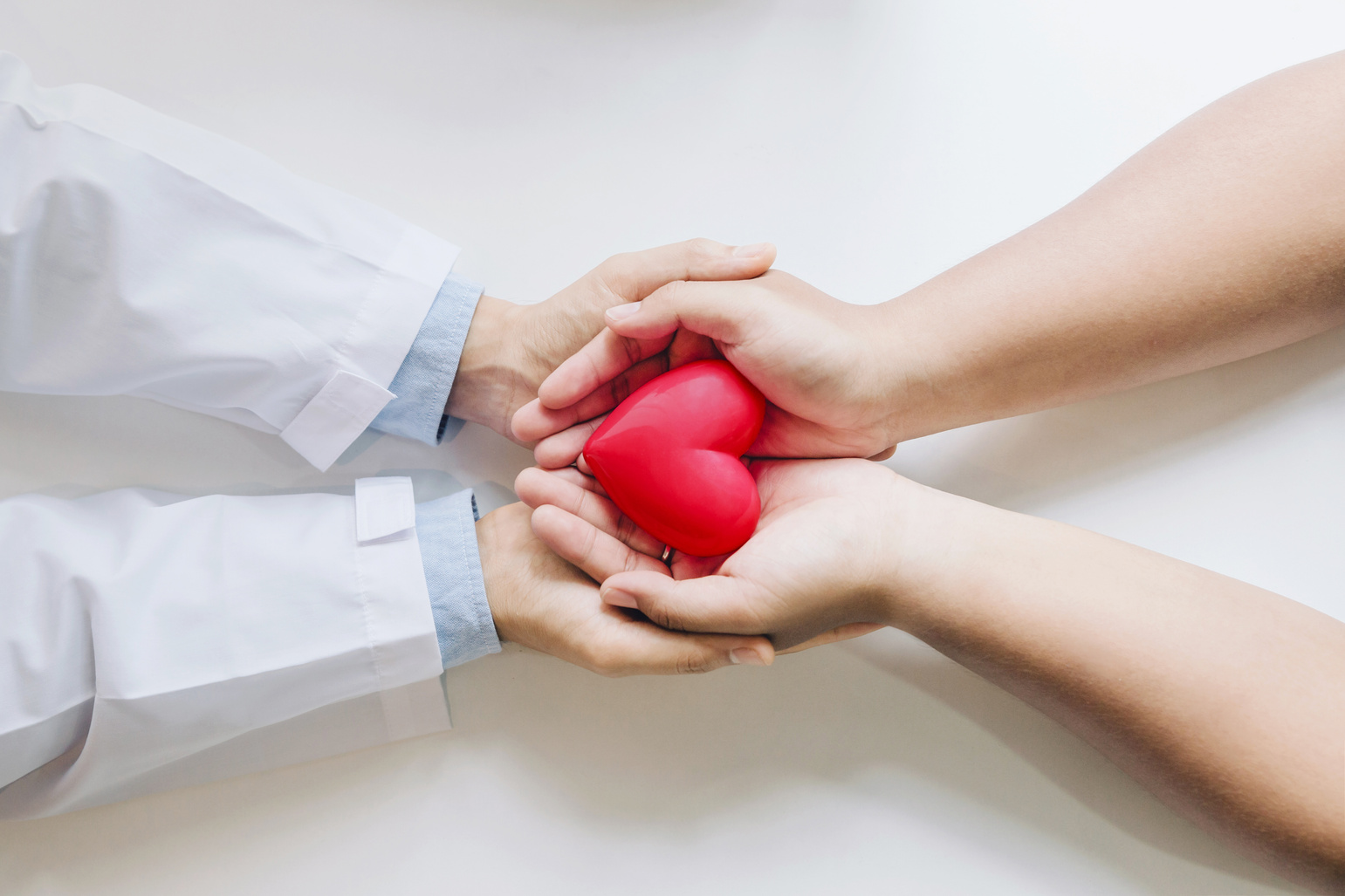 Doctor and Patient Holding a Heart Up Close